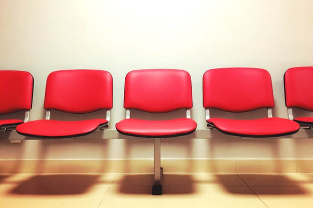 Group of red chairs at a waiting room