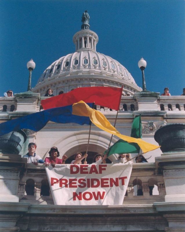 Students at Deaf President Movement standing with banners and flags