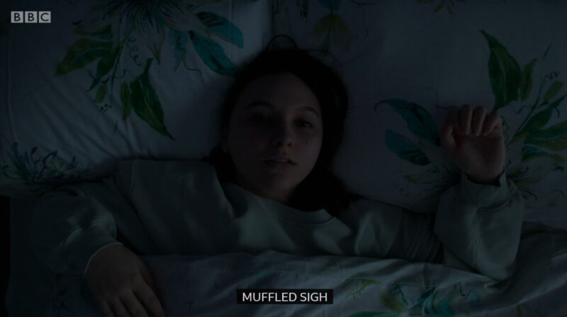 Clip of Casualty where Jade is waking up in the dark and the caption is written "muffled sigh"