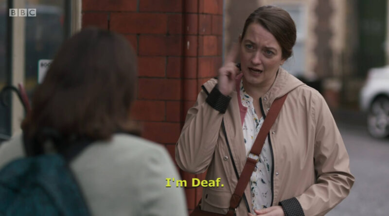 Clip of a Casualty where Susie is signing to Jade and the open-caption at the bottom is "I'm Deaf"